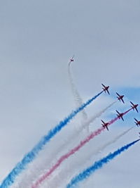 Low angle view of airplane flying against sky