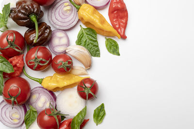 High angle view of chopped fruits against white background