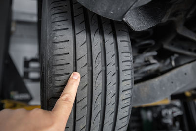 Cropped hand of man repairing car