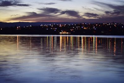 Scenic view of lake against sky at night