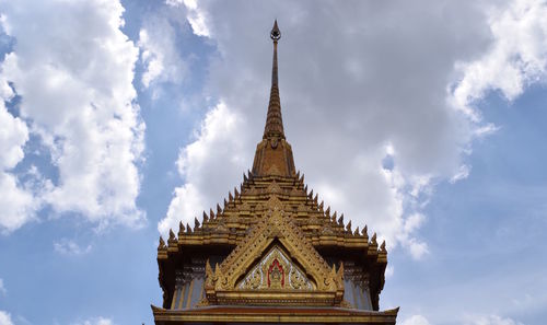 Low angle view of temple against cloudy sky