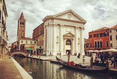 View of cathedral in city against cloudy sky