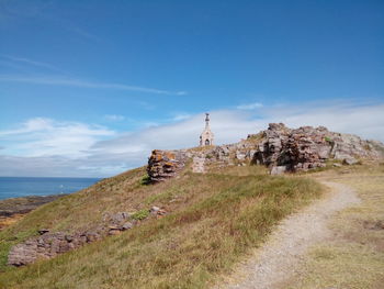 Old chapel on hill against sky