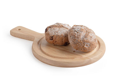 High angle view of bread on cutting board against white background