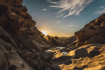 Scenic view of rock formation against sky during sunset