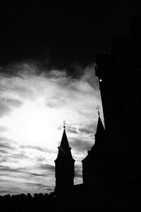 Low angle view of silhouette bell tower against sky