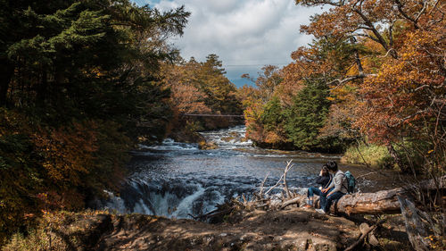 Scenic view of river amidst trees during autumn