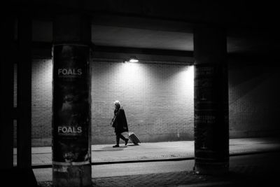 Rear view of woman walking in subway building