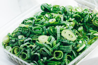 High angle view of chopped scallions in container