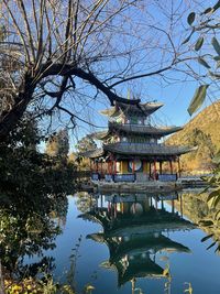 Scenic view of lake by building against sky