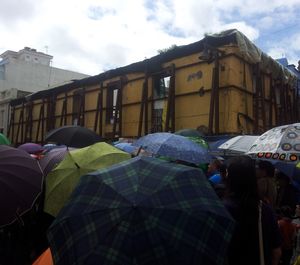 People in front of building against sky