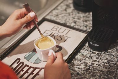 Woman holding coffee cup