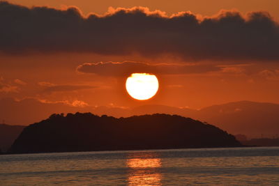 Scenic view of sea against romantic sky at sunset