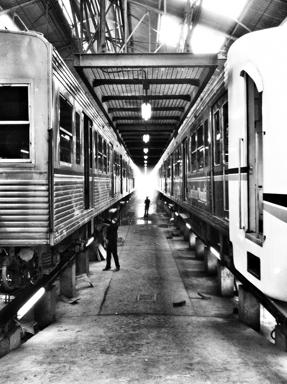 the way forward, indoors, architecture, diminishing perspective, built structure, ceiling, vanishing point, walking, transportation, men, lighting equipment, illuminated, incidental people, arch, corridor, rear view, full length, tunnel