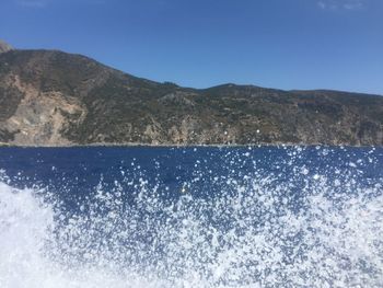 Scenic view of sea against clear blue sky