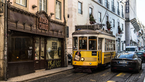 Cars on street amidst buildings in city