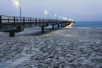 Pier over sea against sky