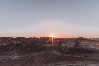 Scenic view of desert against sky during sunset