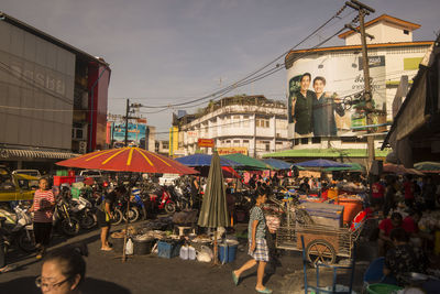 People at market stall in city