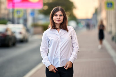 Portrait of beautiful young woman in city