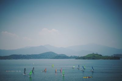 Boats in sea against sky