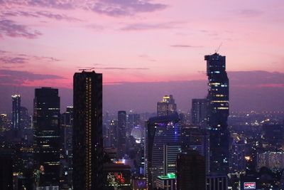 Illuminated city at sunset