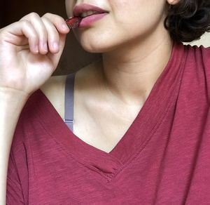 Close-up of woman eating fruit