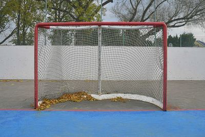 Abandoned hockey goal in fall. concept of finished field hockey season