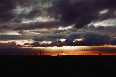 Silhouette of landscape against cloudy sky