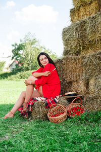 Portrait of young woman sitting on hay