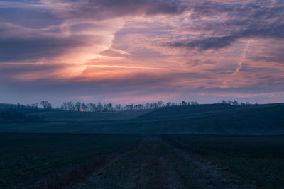 Scenic view of field against sky during sunset