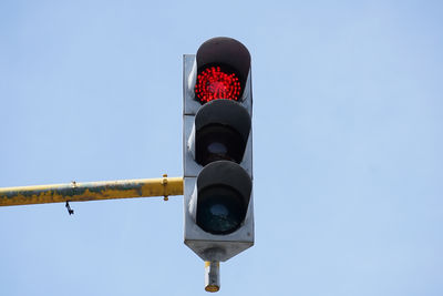 Low angle view of road sign against clear sky