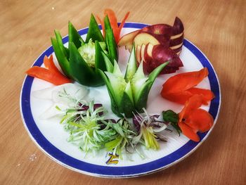 High angle view of chopped vegetables in plate on table