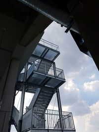 Low angle view of spiral staircase against cloudy sky