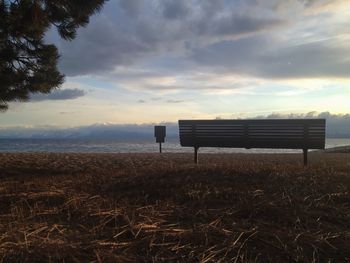 Empty bench against calm sea