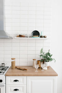 Bright kitchen in the scandinavian style. pasta in a glass jar, houseplant, glasses and utensils