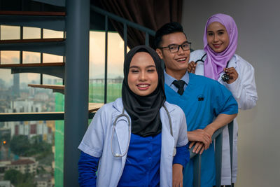 Portrait of smiling young couple standing outdoors