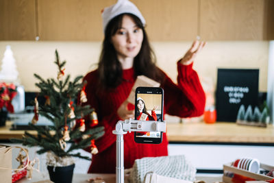 Portrait of young woman sitting on table