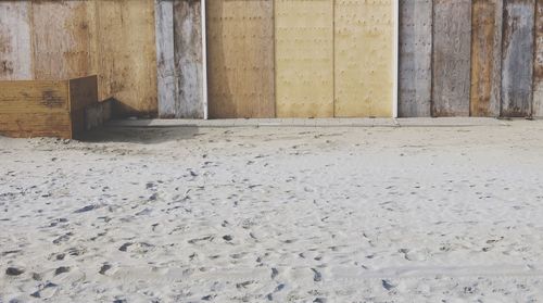 Wooden fence on sand at beach