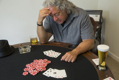 Midsection of man sitting at table