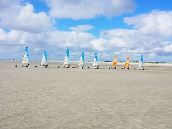 Land yachting on beach against sky