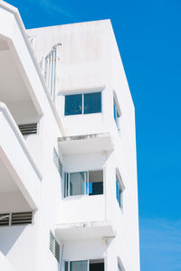 Low angle view of white building against blue sky