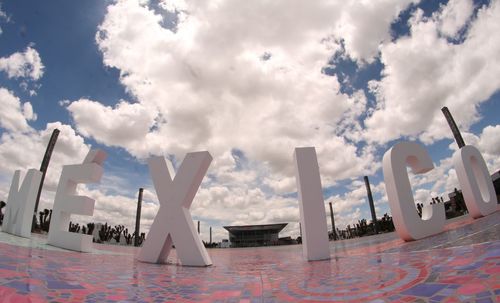 Panoramic view of text on beach against sky