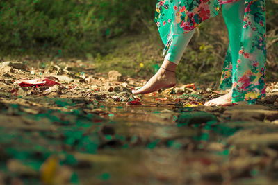 Low section of woman standing on ground