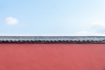 Low angle view of building against cloudy sky