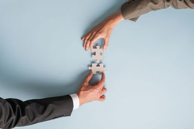 People holding hands over white background