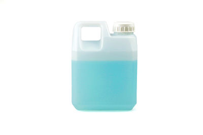 Close-up of blue bottle against white background
