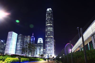 Low angle view of illuminated buildings against sky at night