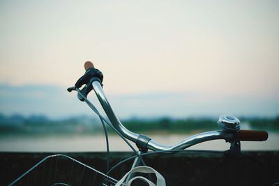 Close-up of bicycle on road against sky
