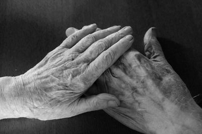 Close-up of human hand against black background